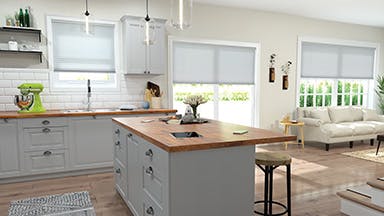 A modern kitchen with automated window treatments, showcasing convenience and style in light control and ambiance management.