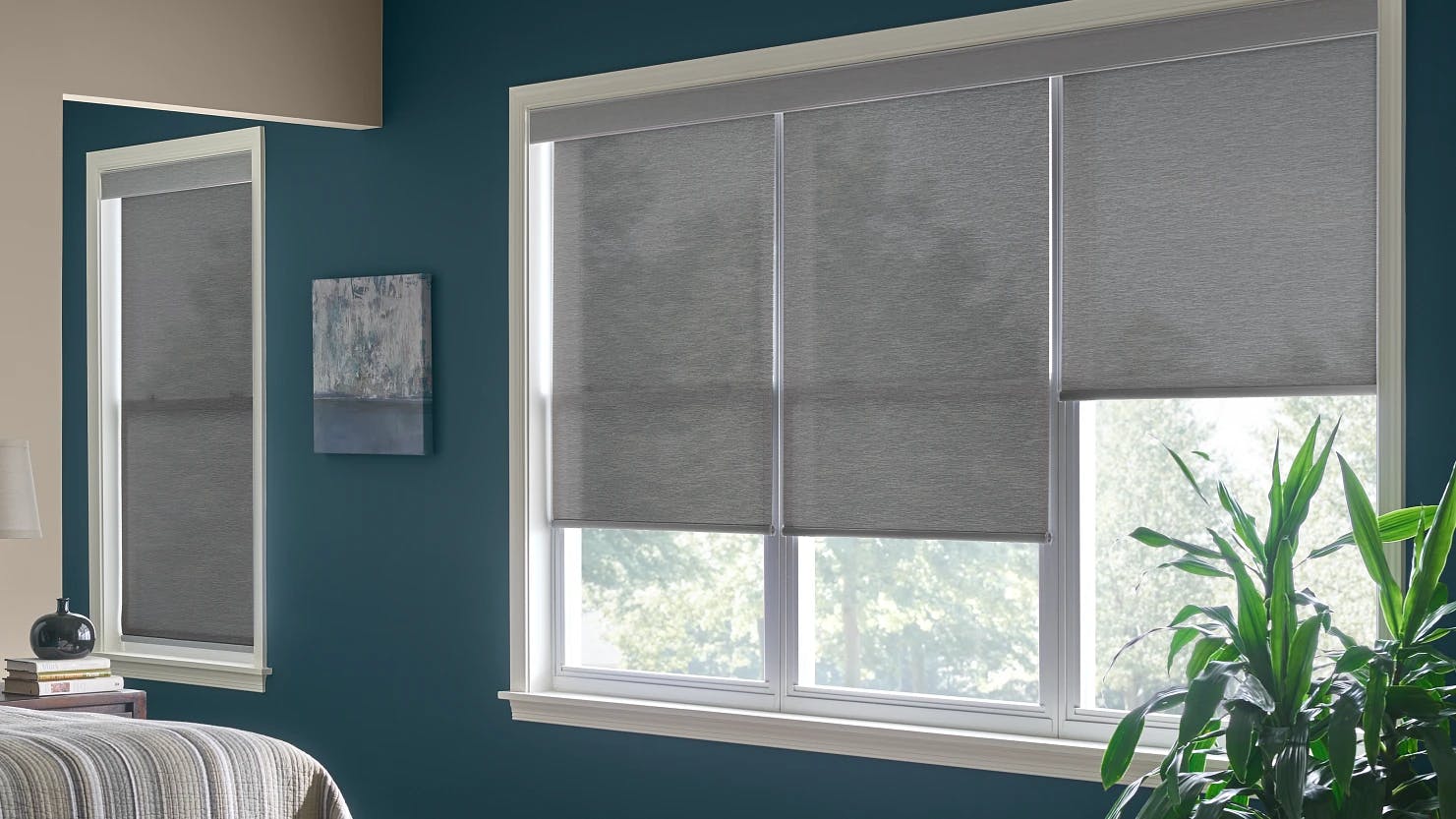 Gray cordless roller shades in a bedroom.