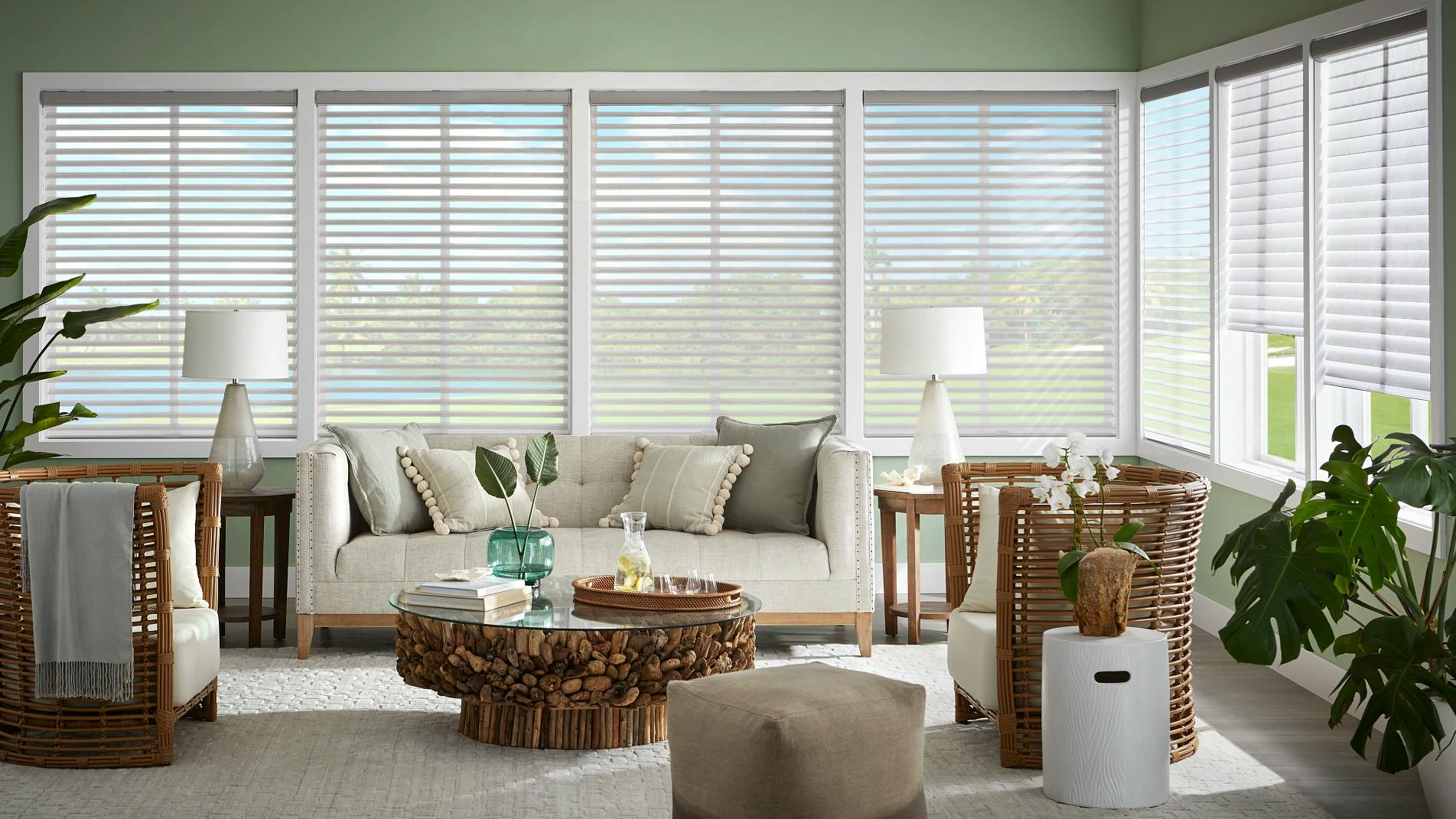 White wood blinds in a large open sunroom.